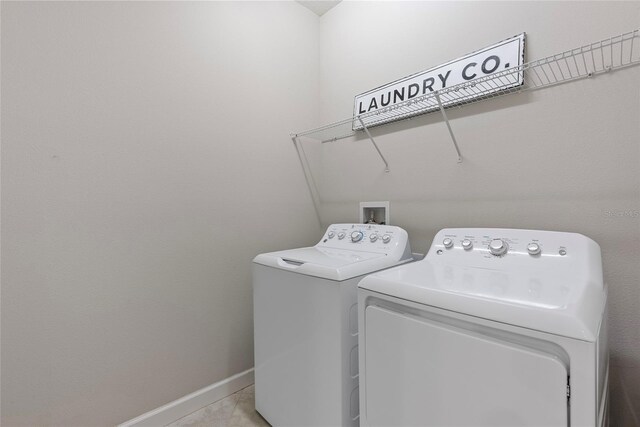 4690 Coachford Dr, Wesley Chapel, FL 33543 - washroom with washing machine and dryer, baseboards, and tile patterned floors