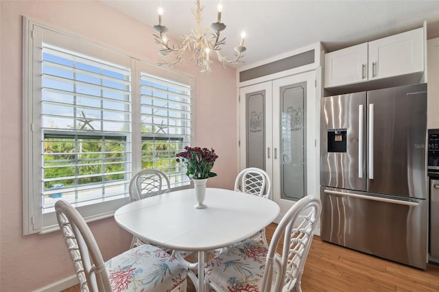 3227 Rose Arbor Dr, Hernando Beach, FL 34607 - dining area with a chandelier and light wood-style floors