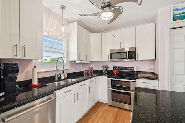 3227 Rose Arbor Dr, Hernando Beach, FL 34607 - kitchen with stainless steel appliances, a sink, ceiling fan, and white cabinets