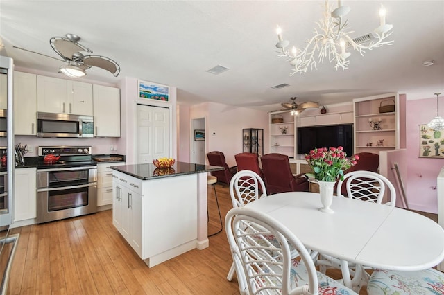 3227 Rose Arbor Dr, Hernando Beach, FL 34607 - kitchen with appliances with stainless steel finishes, dark countertops, white cabinetry, and light wood-type flooring