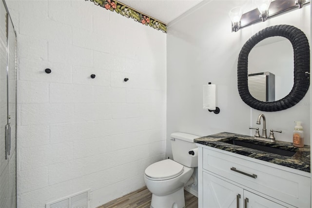 3227 Rose Arbor Dr, Hernando Beach, FL 34607 - bathroom featuring vanity, wood finished floors, and toilet