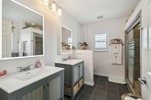 3227 Rose Arbor Dr, Hernando Beach, FL 34607 - full bath featuring two vanities, a stall shower, tile patterned floors, toilet, and baseboards