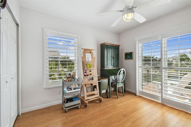 3227 Rose Arbor Dr, Hernando Beach, FL 34607 - home office featuring light wood-style flooring, baseboards, and ceiling fan