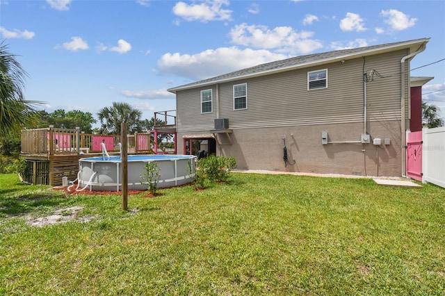 3227 Rose Arbor Dr, Hernando Beach, FL 34607 - back of house featuring a wooden deck, an outdoor pool, and a yard