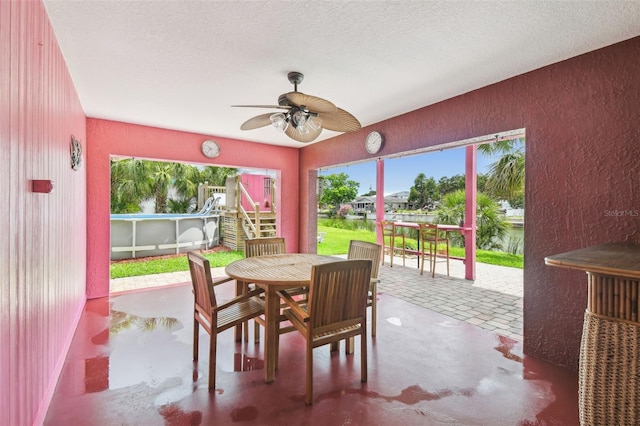3227 Rose Arbor Dr, Hernando Beach, FL 34607 - dining room featuring a textured wall, ceiling fan, and a textured ceiling