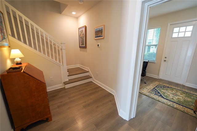 foyer entrance with wood finished floors, stairs, baseboards, and recessed lighting