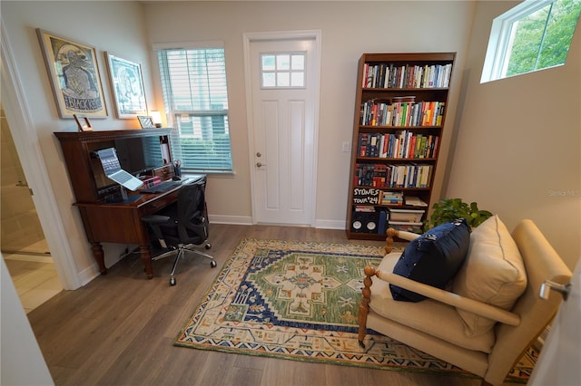 office featuring healthy amount of natural light, wood finished floors, and baseboards