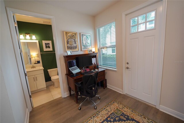 home office with wood finished floors and baseboards