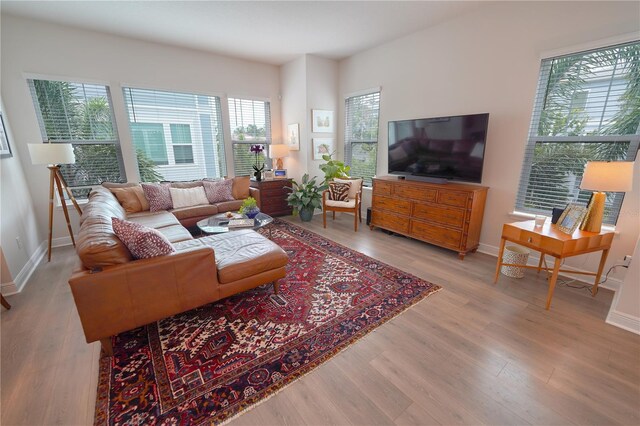 living room with light wood-style floors and baseboards