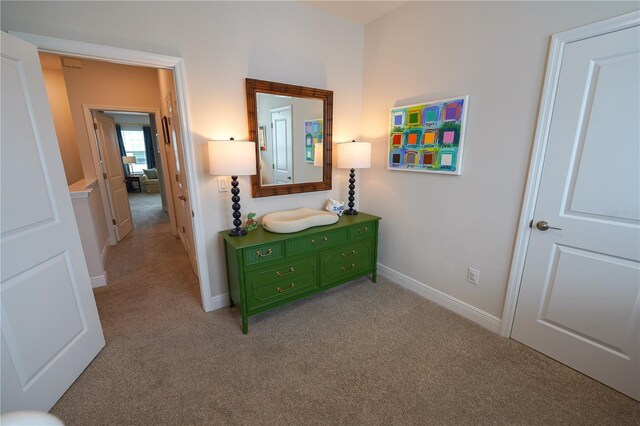 corridor featuring carpet flooring and baseboards