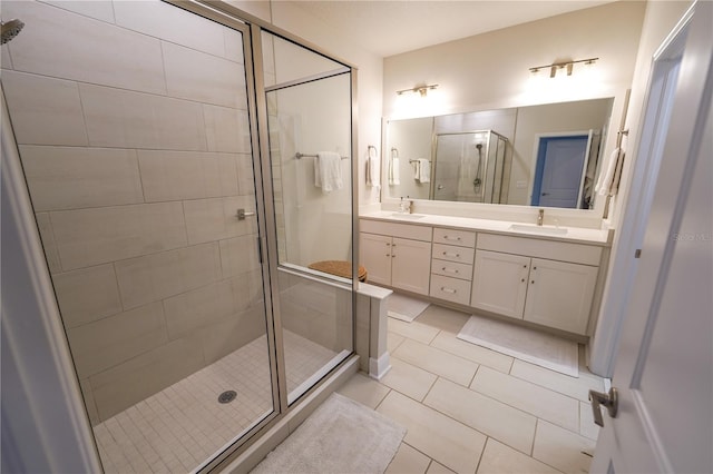 bathroom featuring a stall shower, tile patterned floors, and double vanity