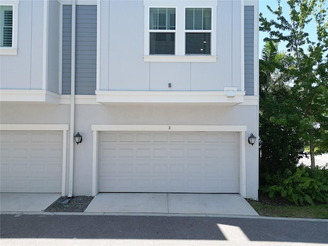 garage featuring concrete driveway