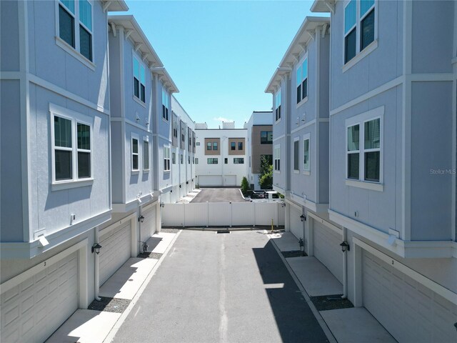 view of patio / terrace featuring a garage and fence
