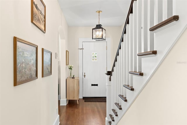 455 18th Ave NE, Saint Petersburg, FL 33704 - entrance foyer with wood finished floors, stairway, a chandelier, and baseboards