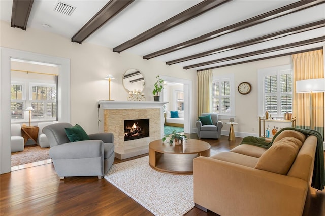 455 18th Ave NE, Saint Petersburg, FL 33704 - living area featuring dark wood finished floors, beam ceiling, a lit fireplace, and baseboards