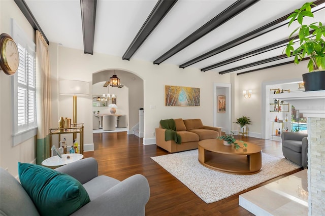 455 18th Ave NE, Saint Petersburg, FL 33704 - living area with wood finished floors, arched walkways, beamed ceiling, baseboards, and a chandelier