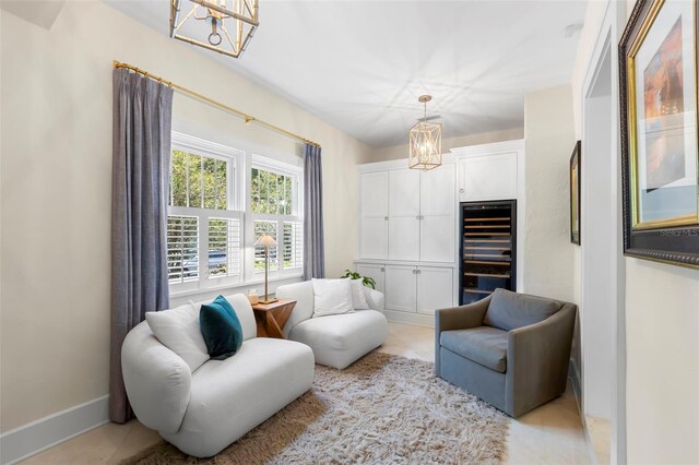 455 18th Ave NE, Saint Petersburg, FL 33704 - sitting room with a chandelier, wine cooler, baseboards, and light tile patterned flooring