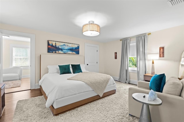 455 18th Ave NE, Saint Petersburg, FL 33704 - bedroom featuring baseboards and wood finished floors