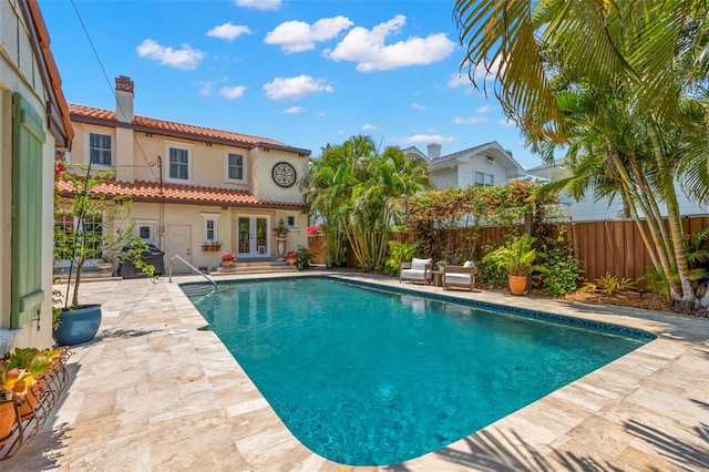 455 18th Ave NE, Saint Petersburg, FL 33704 - view of swimming pool featuring french doors, a patio, and a fenced backyard