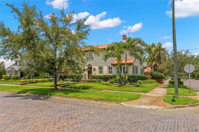 455 18th Ave NE, Saint Petersburg, FL 33704 - mediterranean / spanish-style house with a chimney, a front yard, and a tiled roof
