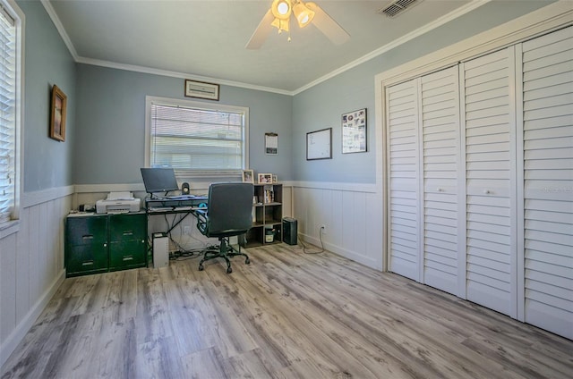 home office featuring wood finished floors, ceiling fan, a wainscoted wall, and crown molding