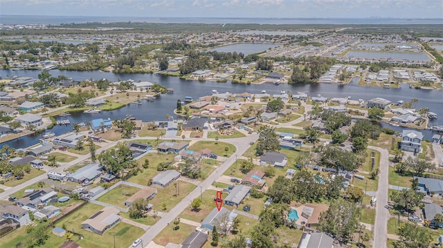 aerial overview of property's location with a large body of water and nearby suburban area