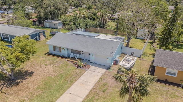 aerial view of property and surrounding area featuring a tree filled landscape