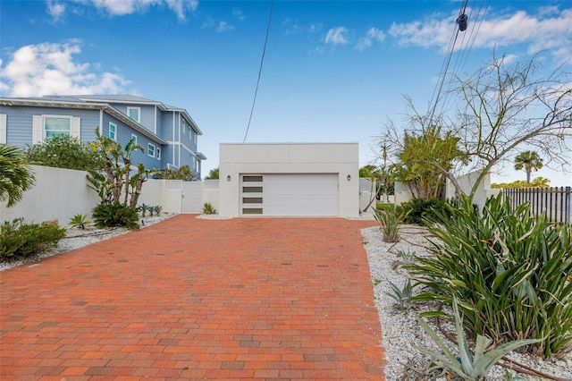 321 N Blvd Of The Presidents, Sarasota, FL 34236 - garage featuring decorative driveway, fence, and a gate