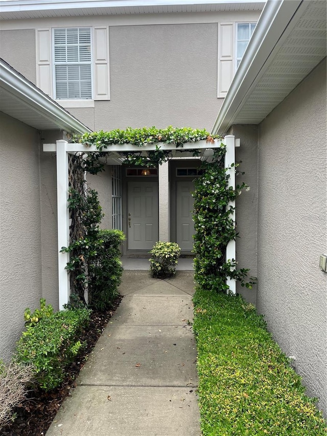 entrance to property with stucco siding