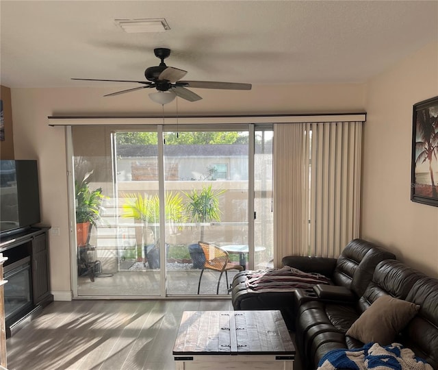 living room featuring wood finished floors and a ceiling fan