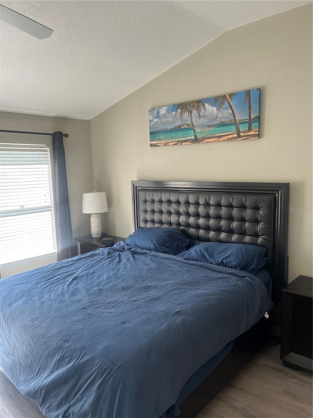 bedroom with wood finished floors and a textured ceiling