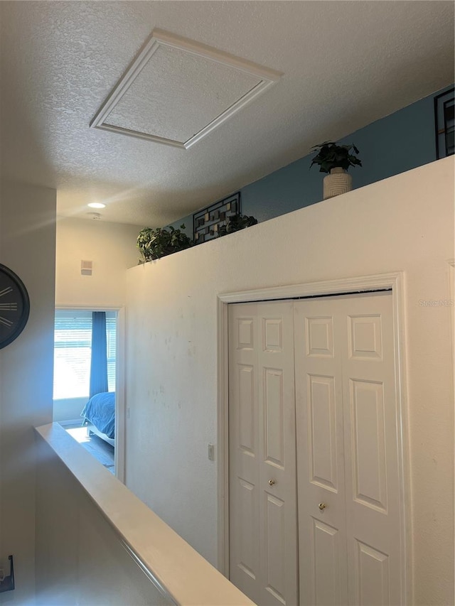 hall with a textured ceiling