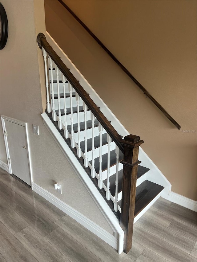 stairs featuring baseboards and wood finished floors