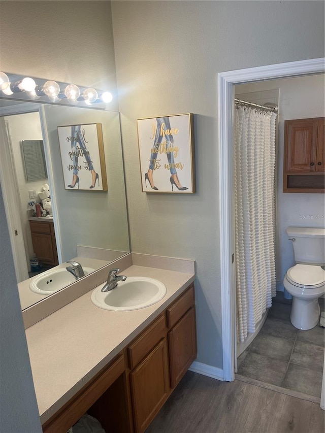 full bathroom with toilet, vanity, wood finished floors, baseboards, and a shower with shower curtain