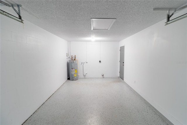 garage featuring water heater and concrete block wall