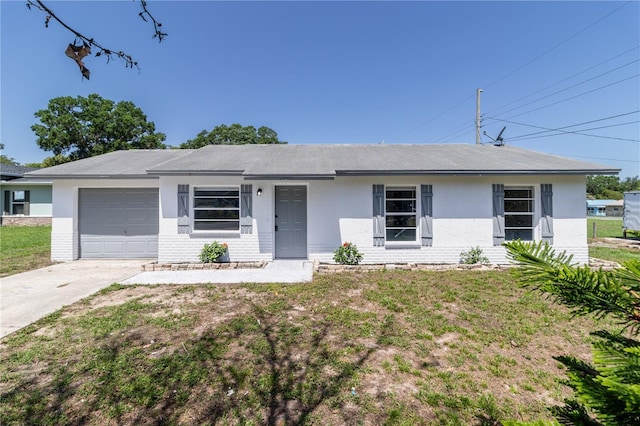 ranch-style home featuring a garage, driveway, stucco siding, and a front lawn