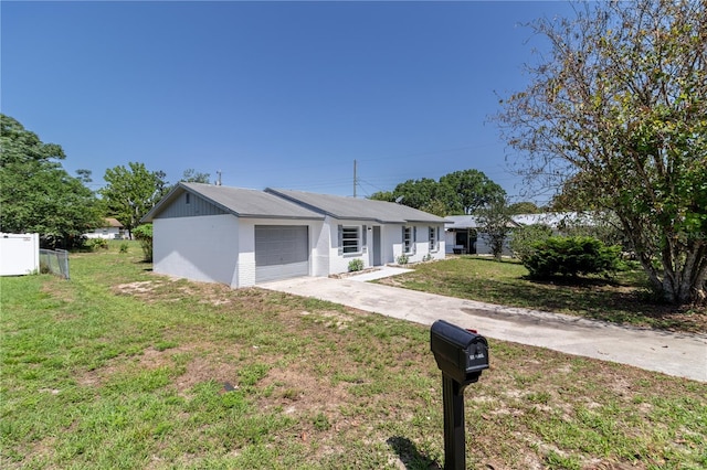 ranch-style home featuring concrete driveway and a garage