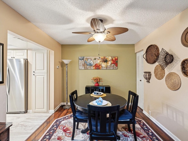 5729 Calais Blvd N Unit 6, Saint Petersburg, FL 33714 - dining room with wood finished floors, ceiling fan, a textured ceiling, and baseboards