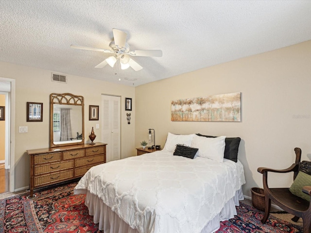 5729 Calais Blvd N Unit 6, Saint Petersburg, FL 33714 - bedroom featuring a closet, a textured ceiling, ceiling fan, dark colored carpet, and baseboards