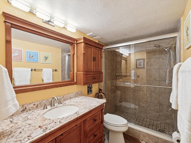 5729 Calais Blvd N Unit 6, Saint Petersburg, FL 33714 - bathroom with a shower stall, vanity, a textured ceiling, and toilet