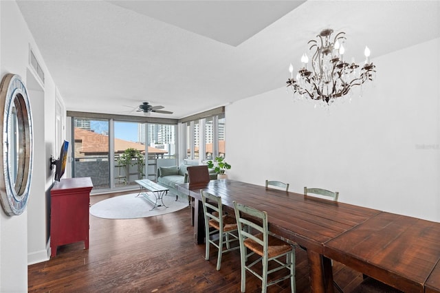 dining room with wood finished floors, a ceiling fan, and a chandelier