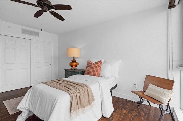 bedroom featuring wood finished floors, a closet, baseboards, and a ceiling fan