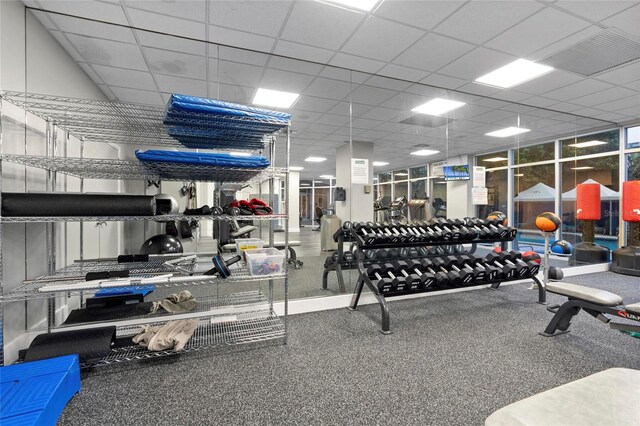 gym with a paneled ceiling