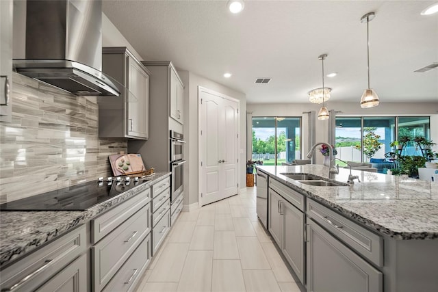 31643 Colada Drift Way, Wesley Chapel, FL 33545 - kitchen with a sink, wall chimney range hood, appliances with stainless steel finishes, gray cabinetry, and recessed lighting