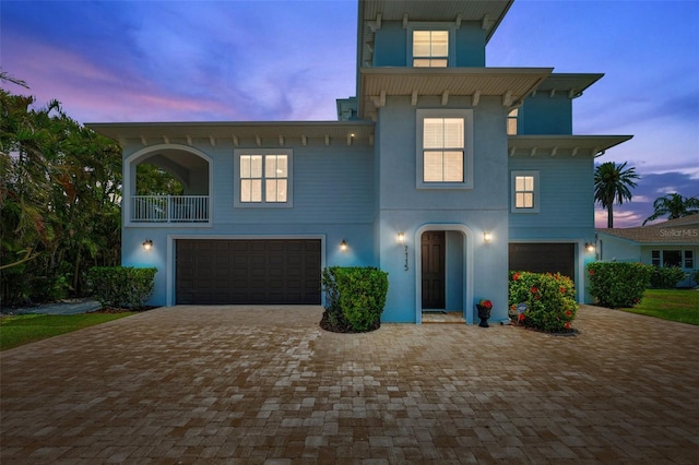 7115 Bay St, St Pete Beach, FL 33706 - raised beach house featuring a garage, decorative driveway, and stucco siding