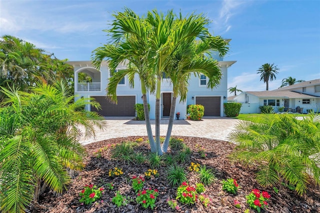 7115 Bay St, St Pete Beach, FL 33706 - view of front of house featuring an attached garage and driveway