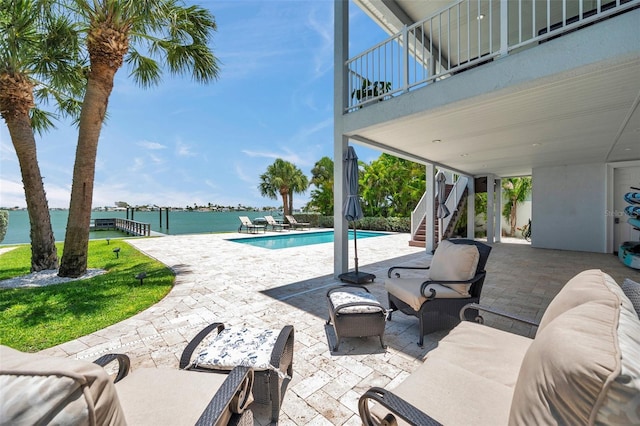 7115 Bay St, St Pete Beach, FL 33706 - outdoor pool featuring stairs, a patio area, and a water view