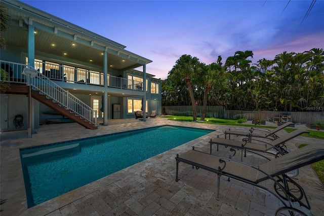 7115 Bay St, St Pete Beach, FL 33706 - view of swimming pool with a patio, stairway, and a fenced backyard