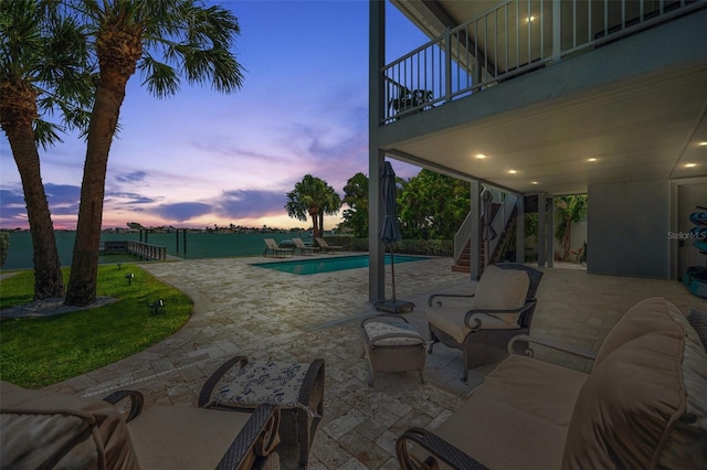 7115 Bay St, St Pete Beach, FL 33706 - pool at dusk with stairs, a patio area, and an outdoor pool
