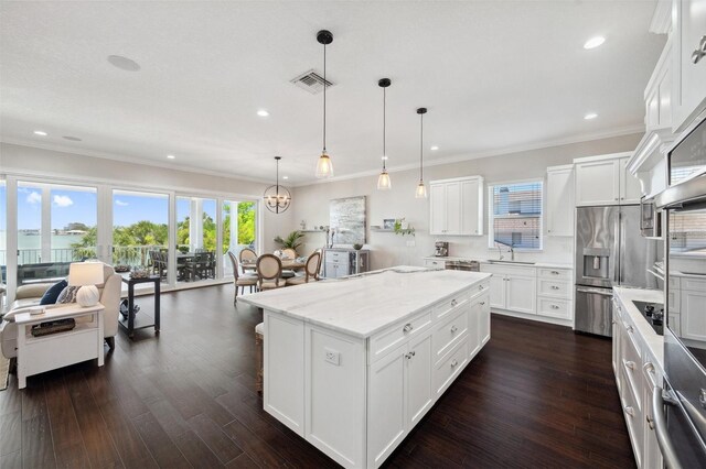 7115 Bay St, St Pete Beach, FL 33706 - kitchen featuring a sink, stainless steel fridge, recessed lighting, dark wood finished floors, and a kitchen island